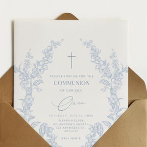 May include: A white invitation card with blue floral accents and a cross design. The text reads "Please join us for the Communion of our son Owen" with event details. The card is inside a brown envelope.
