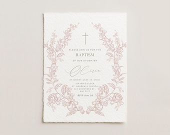 May include: Baptism invitation on textured white paper. The invitation features a floral wreath design in a soft pink hue, surrounding the text. The text includes the name "Olivia", date, time, and location details.