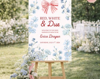 Puede incluir: Un caballete de madera exhibe un letrero con el texto "RED, WHITE & DUE" y detalles florales. El letrero da la bienvenida a los invitados a un baby shower para Erica Draper, programado para el 4 de julio de 2026. Hay un lazo rojo y blanco en la parte superior.