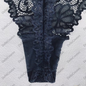 May include: Black lace underwear with a delicate floral pattern.