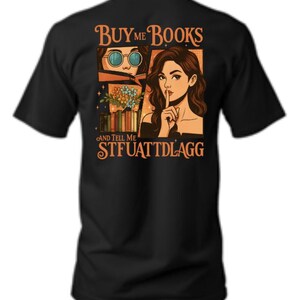 May include: Black t-shirt with a graphic featuring two illustrations and text. One illustration shows a person wearing sunglasses, and the other shows a person with a finger to their lips. The text reads "Buy Me Books And Tell Me STFUATTDLAGG."