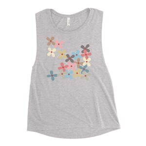 May include: A gray sleeveless muscle tank top with a colorful floral print. The flowers are in shades of pink, blue, yellow, and green.