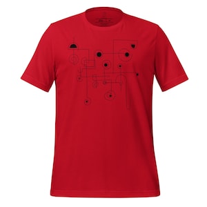 Puede incluir: Una camiseta roja con un diseño geométrico abstracto negro. El diseño incluye líneas, círculos y semicírculos. La camiseta tiene mangas cortas y cuello redondo.