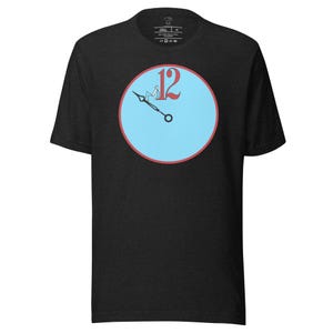 May include: Black t-shirt with a blue circle and a red clock face with the number 12 on it. The clock hands are pointing to the 12.