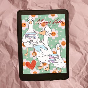 May include: An e-reader displays a whimsical illustration of three geese reading books. The background is a light green color with white flowers and smiling faces. The text "Mary's Kobo" and "Do Not Disturb" is visible.