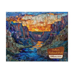May include: A mosaic-style artwork depicting a canyon landscape with a river. The artwork features a vibrant color palette of blues, oranges, and purples. The text "Badlands National Park Wilsons 2024" is displayed on a wooden sign.