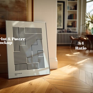 May include: A framed poster mockup leaning against a wall. The poster has a black and white geometric design with "BAUHAUS" at the bottom. The text "Print & Poster Mockup" is visible. The image is set in a room with wooden flooring.