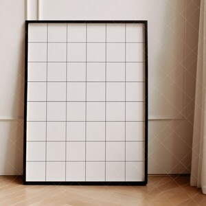 May include: A black framed grid board with a white background. The board is standing on a wooden floor.