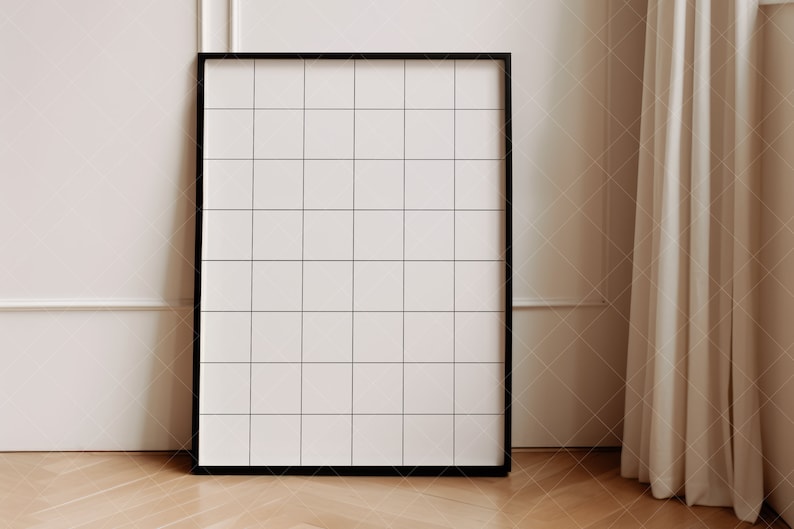 May include: A black framed grid board with a white background. The board is standing on a wooden floor.
