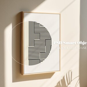 May include: A framed print featuring a black and white geometric design in the shape of a semi-circle. The print is in a light wood frame and is hanging on a white wall. The text "PSD Smart Object QUICK & EASY TO USE" is visible in the bottom right corner of the print.