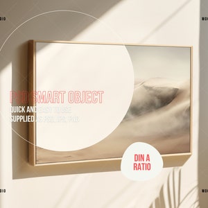 May include: A framed print of a desert landscape with sand dunes. The frame is a light wood colour and the print is in a muted colour palette. The print is labelled "DIN A RATIO".