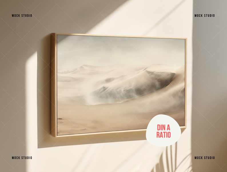 May include: A framed print of a desert landscape with sand dunes and a hazy sky. The frame is a light wood colour. The print is in a DIN A ratio.