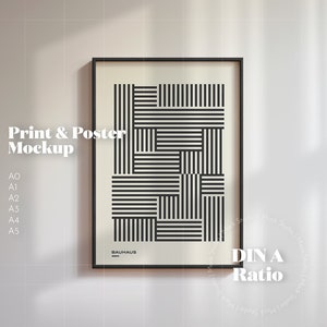 May include: A black framed poster mockup with a geometric black and white design. The poster is labeled "Bauhaus" and "DIN A Ratio".
