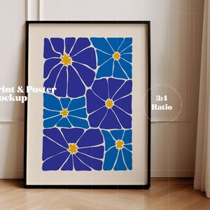 May include: A framed print with a geometric design of blue and yellow flowers. The print is in a black frame and is hanging on a white wall.