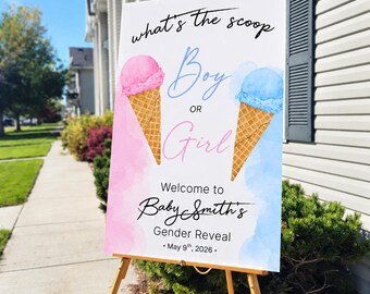 May include: A white rectangular sign on a gold tripod stand featuring two ice cream cones, one with pink and one with blue scoops. Text reads: what's the scoop Boy OR Girl Welcome to Baby Smith's Gender Reveal May 9th, 2026. Pink and blue watercolor accents.