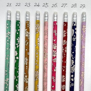 May include: Nine pencils with different floral patterns. The pencils are numbered 21 through 29. The pencils are all the same size and have a silver eraser.