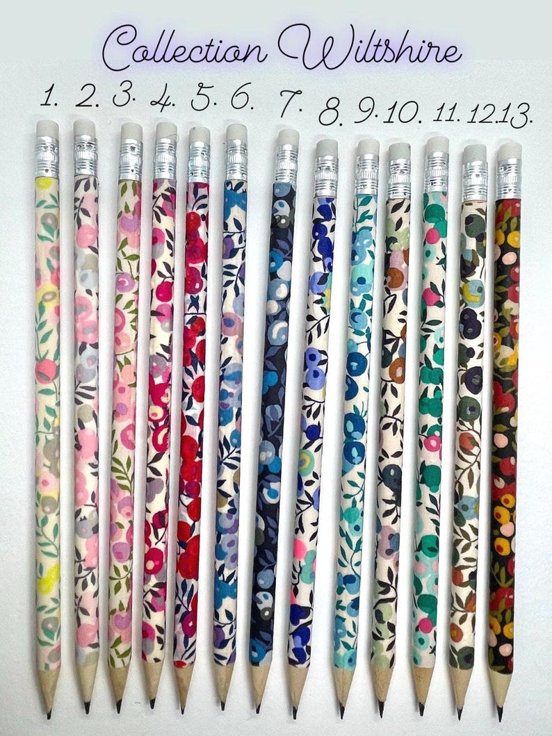 May include: A set of 13 pencils with different floral patterns. The pencils are all white with a black eraser and a silver band around the eraser. The pencils are numbered 1 through 13. The text "Collection Wiltshire" is at the top of the image.
