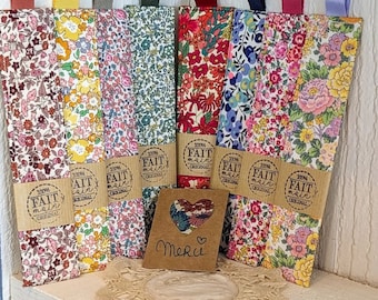 May include: Eight handmade fabric bookmarks with floral patterns in various colours. Each bookmark has a label that reads "100% Fait Main Original".