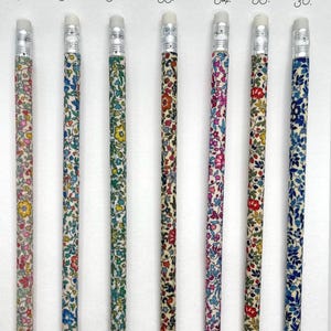 May include: Seven pencils with white erasers and floral patterned wood. The pencils are numbered 30 through 36.