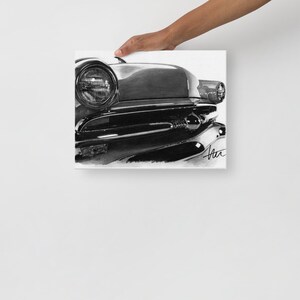 May include: Black and white pencil drawing of the front end of a classic car. The car's headlights and grille are in focus, with the rest of the car blurred in the background.