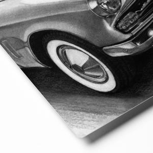 May include: Black and white pencil drawing of a vintage car with a whitewall tyre. The car is drawn in detail, including the headlights, grille, and chrome trim.