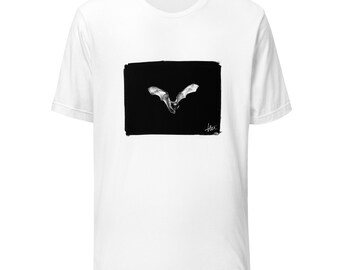 May include: White t-shirt with a black and white image of a bat in flight. The image is framed in a black rectangle with a white border.