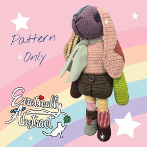 May include: A crocheted rabbit doll with a purple head, long pink ears, a light green scarf, dark brown shorts, and mismatched limbs in shades of green, pink, and brown. The text "Pattern Only" and "Erratically Abstract" appears on the left side.