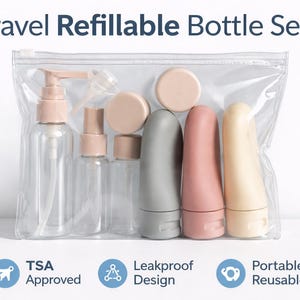 May include: A travel refillable bottle set in a clear plastic bag. The set includes clear bottles with pink tops and sprayers, and gray, pink, and beige squeeze bottles. The text "Travel Refillable Bottle Set" is at the top.