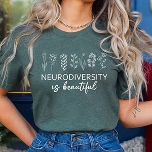 May include: A green t-shirt with a white graphic of flowers and the text "Neurodiversity is beautiful".