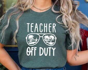 May include: A green t-shirt with the text "Teacher Off Duty" and a graphic of sunglasses with palm trees reflected in the lenses.