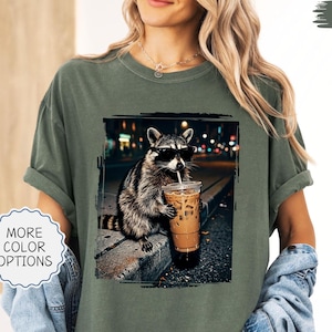 Comfort Colors® Funny Raccoon Drinking Iced Coffee Shirt: Animal Meme Graphic Tee