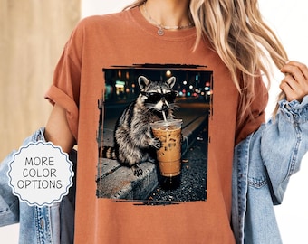 Comfort Colors® Funny Raccoon Drinking Iced Coffee Shirt: Animal Meme Graphic Tee