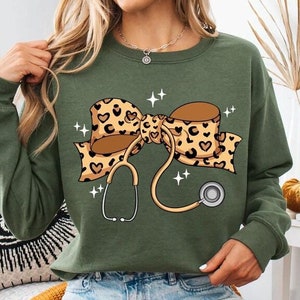Coquette Nurse Stethoscope Bow Sweatshirt, Gift for Nurse, Nurse Bow Sweatshirt, Coquette Nurse Shirt, Nurse Gift,Leopard Nurse Ribbon Shirt