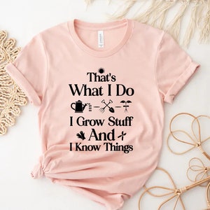 May include: A pink t-shirt with a black graphic that says "That's What I Do - I Grow Stuff And I Know Things" with gardening icons.