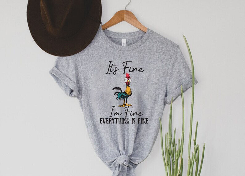 May include: Gray t-shirt with a cartoon rooster and the text "It's Fine, I'm Fine, Everything is Fine."