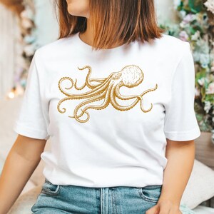 May include: White t-shirt with a gold outline drawing of an octopus.