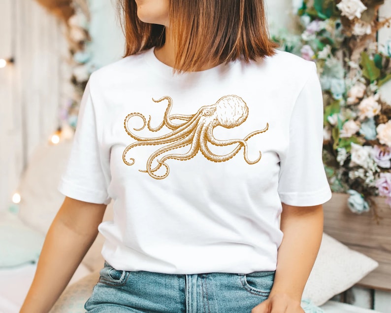 May include: White t-shirt with a gold outline drawing of an octopus.