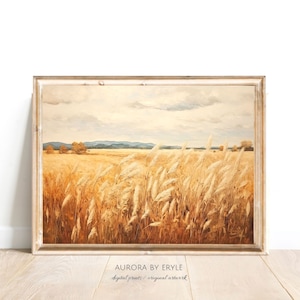 May include: A painting of a field of tall, golden wheat blowing in the wind. The sky is a soft blue with white clouds. The painting is framed in a light wood frame.