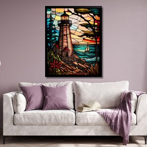 May include: A stained glass artwork depicting a lighthouse on a rocky shore with a sailboat in the distance. The sky is a vibrant blue and orange, and the water is a deep blue. The lighthouse is white with a red roof and a black lantern.