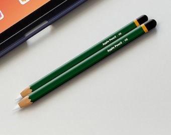 May include: Two green pencils with white tips and black eraser tops. The pencils are labeled "Apple Pencil | HB".