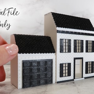 May include: A digital file download for a 3D printable model of a white two-story house with a black roof and black windows. The house has a garage door and a front door. The text "Digital File Only" is visible in the image.
