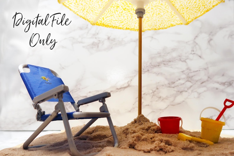 May include: A blue beach chair with a yellow and blue design sits in the sand under a yellow and white striped beach umbrella. There is a red bucket and a yellow bucket with a red shovel in the sand.