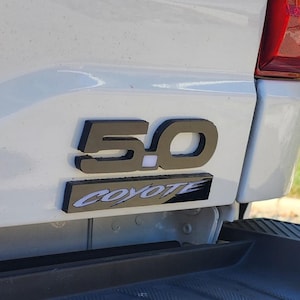 5.0 coyote badges.  each order contains 2 sets of badges (2x 5.0 emblems and 2x coyote logos)