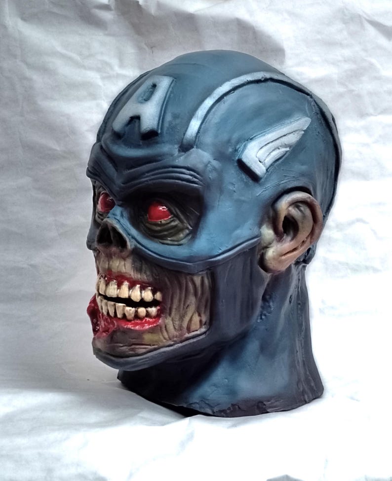 May include: A blue and white zombie Captain America mask with red eyes and a torn mouth. The mask is made of plastic and has a realistic look.