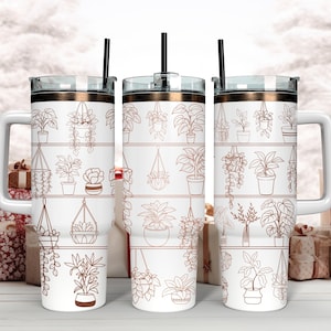 Può includere: Tre bicchieri in acciaio inossidabile bianco con bordo e coperchio in oro rosa. Ogni bicchiere presenta un motivo di piante in vaso in un design lineare. Le piante sono delineate in oro rosa.