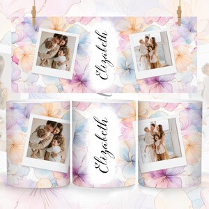 May include: Two white mugs with a watercolor floral design and a photo of a family. The mugs have the name "Elizabeth" written on them.