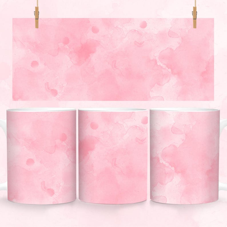 May include: Three white ceramic mugs with a pink watercolor design. The design features light and dark pink shades of watercolor paint.