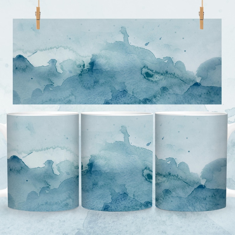May include: Three white ceramic mugs with a blue watercolor design. The design features abstract shapes and swirls in shades of blue.