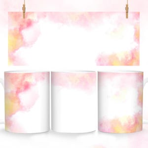 May include: Three white ceramic mugs with a pink and yellow watercolor design. The design features a soft, abstract pattern of pink and yellow clouds.