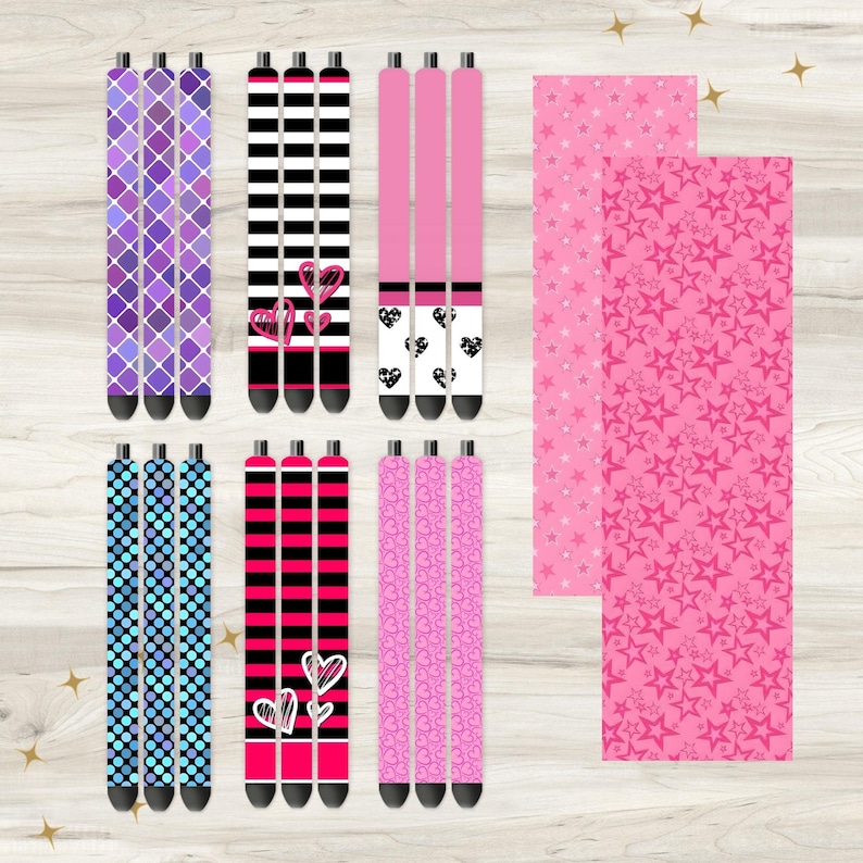 May include: Set of 10 colorful patterned pens with different designs, including hearts, stars, and geometric patterns. The pens are arranged in three rows on a wooden surface.